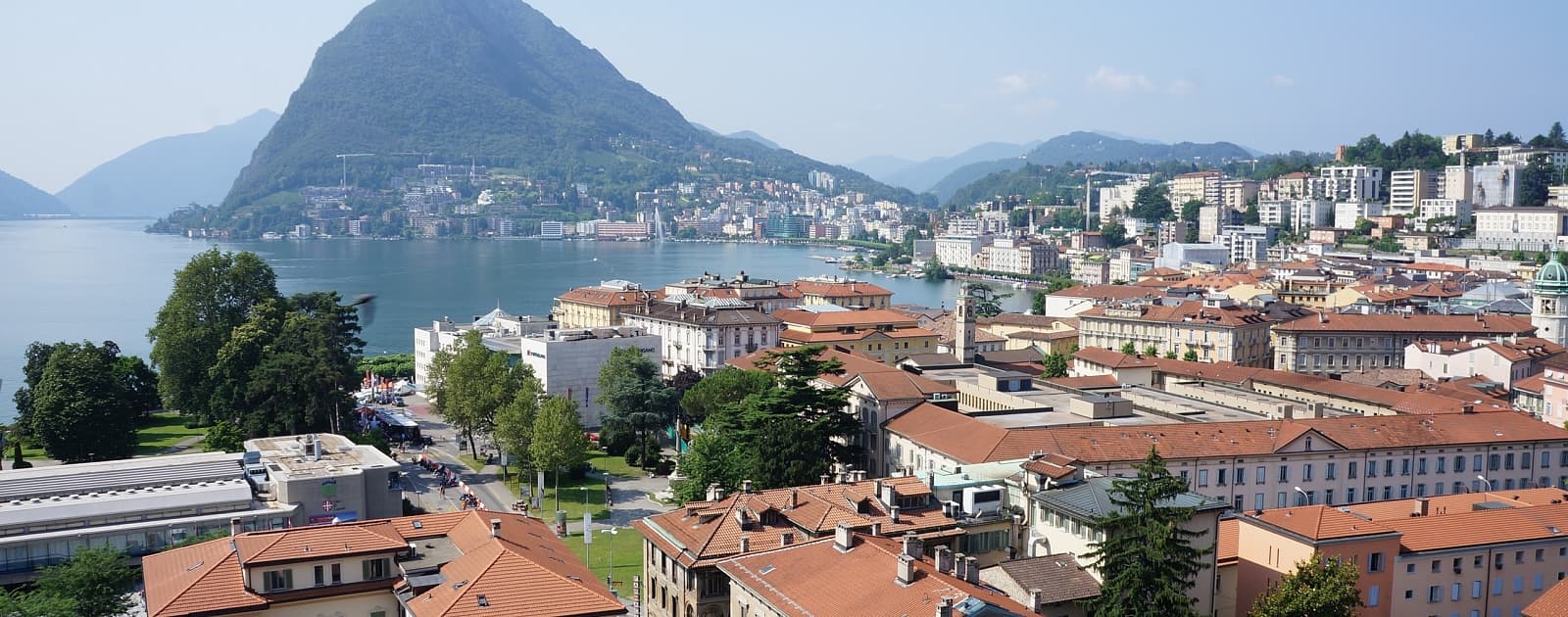 View over the rooftops of Lugano with the lake and Monte San Salvatore.