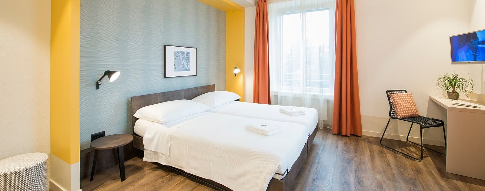 Room at Hotel Pestalozzi in Lugano with a wall-mounted TV.
