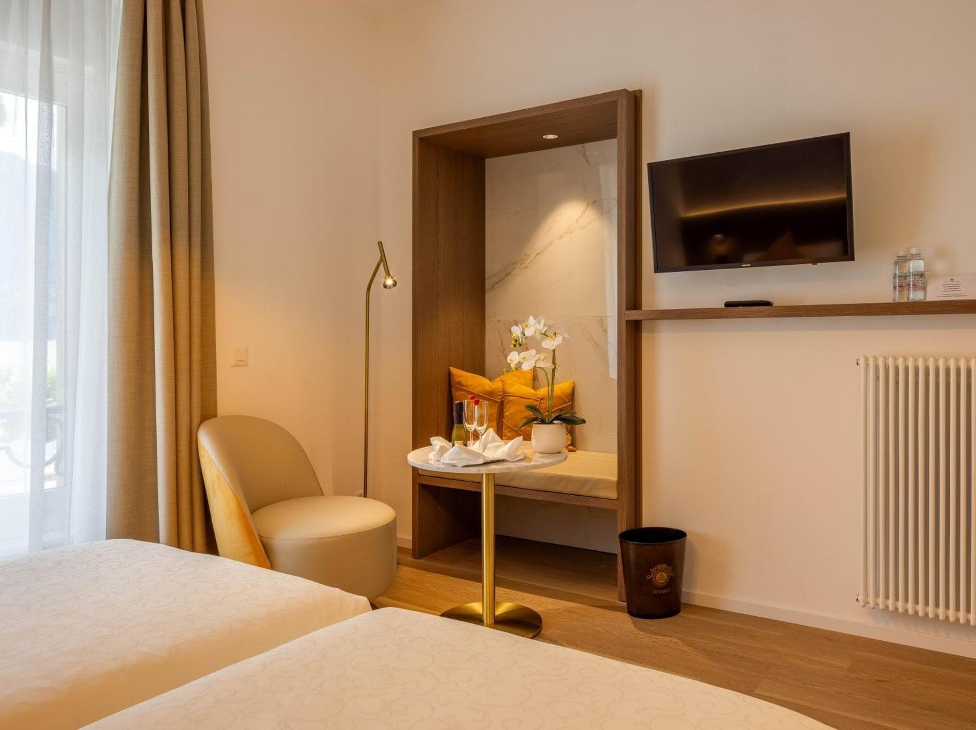 Camera dell’Hotel Walter au Lac a Lugano con televisore nella nicchia di marmo.